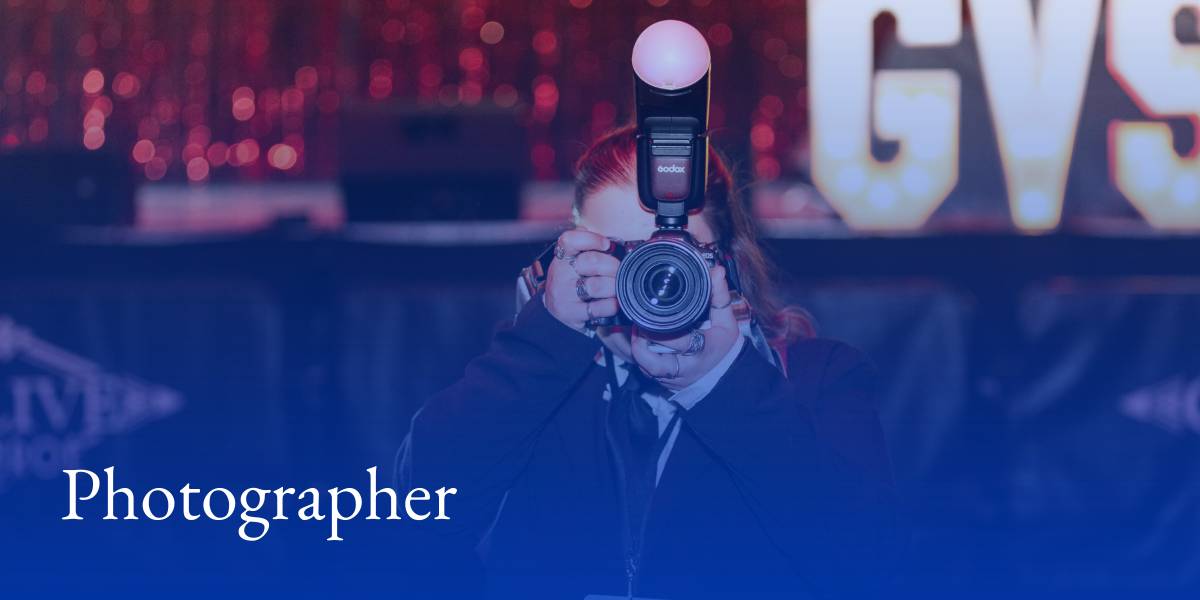 A student pointing a camera directly at the camera. Text reads "photographer".